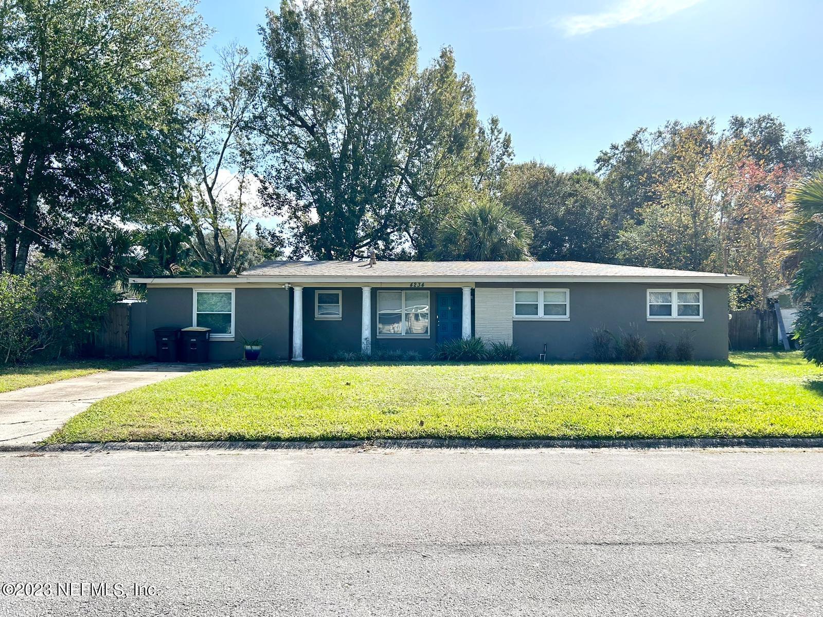 a front view of a house with a yard and a garage