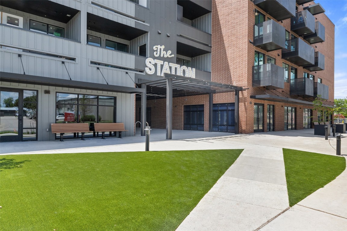 a view of an apartment with a swimming pool and sitting area