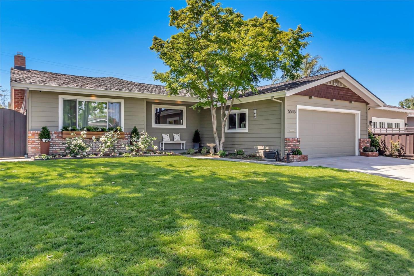 a front view of house with yard and outdoor seating