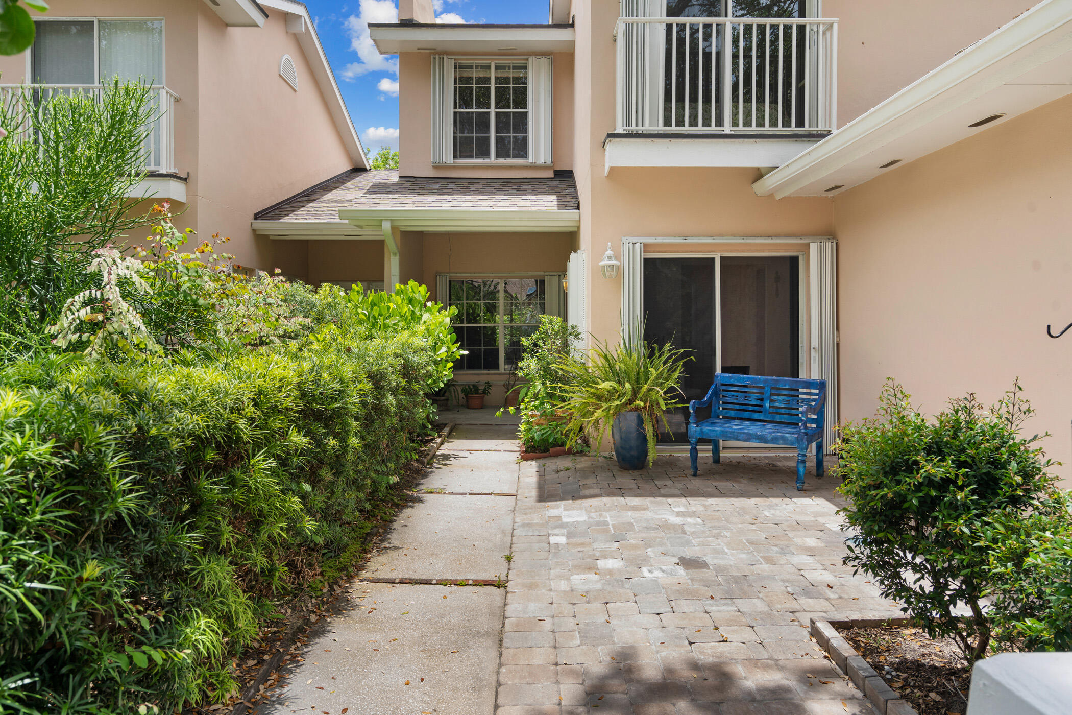 a view of a house with potted plants