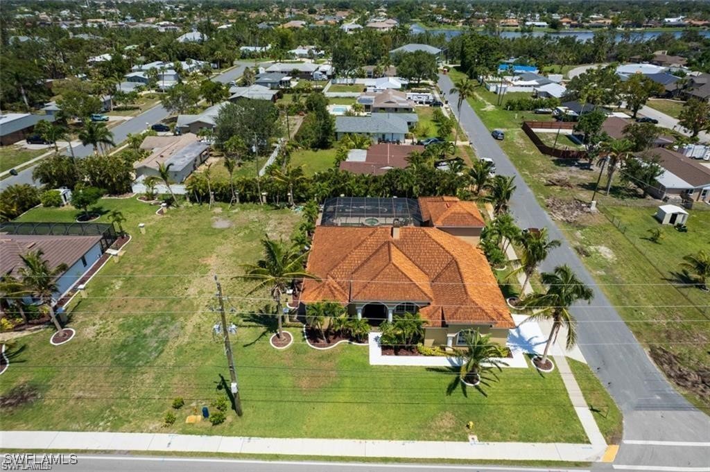 an aerial view of residential houses with outdoor space and swimming pool