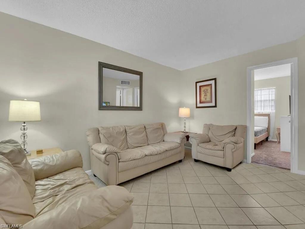 a living room with furniture and a lamp