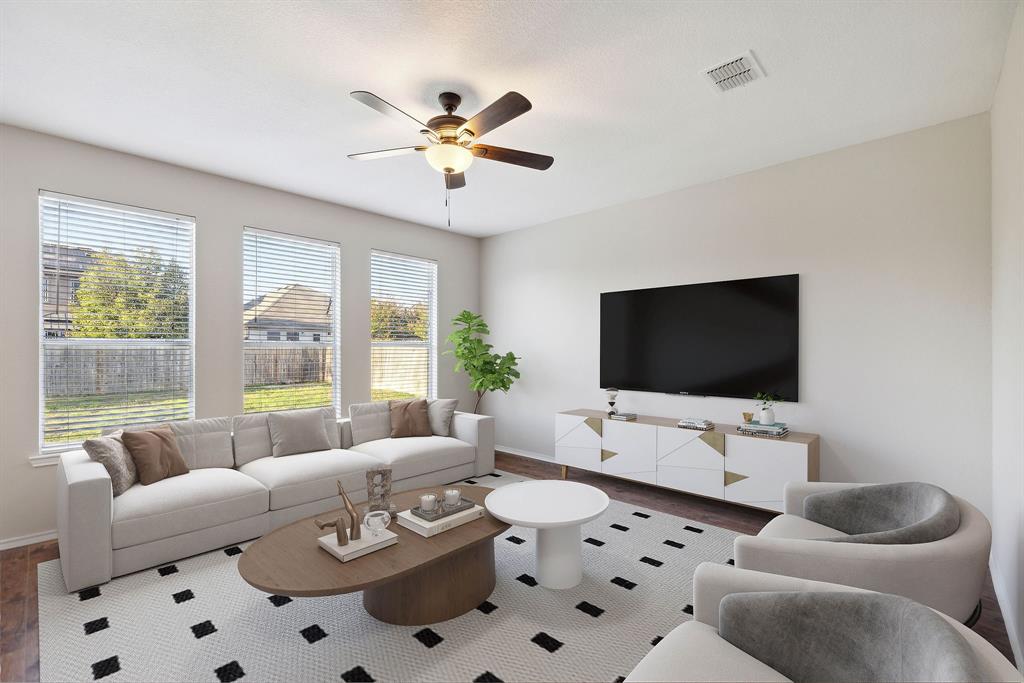 a living room with furniture a large window and a flat screen tv