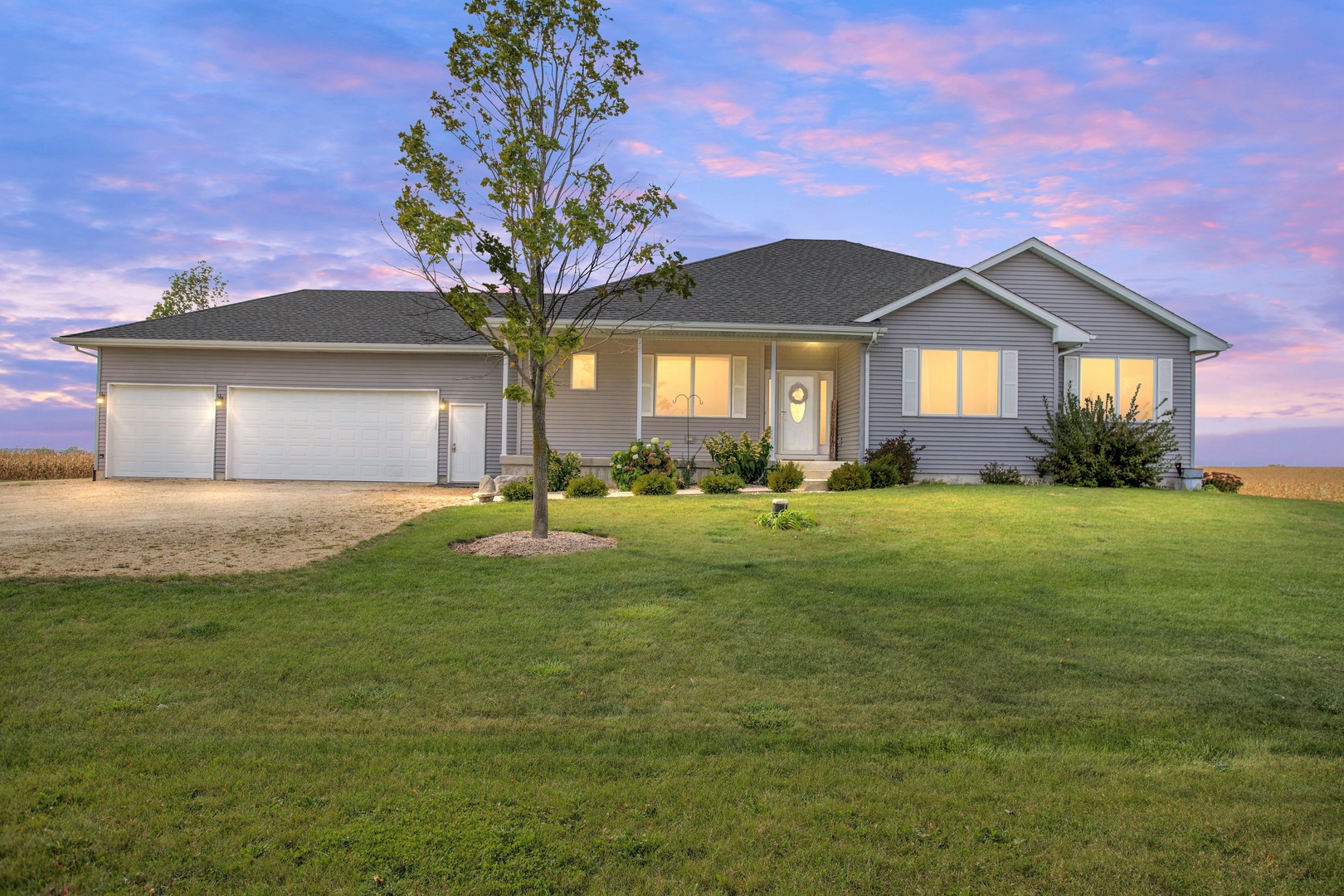 a front view of a house with a yard and garage