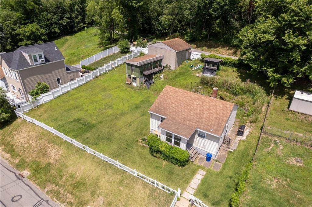 an aerial view of a house with a garden and swimming pool