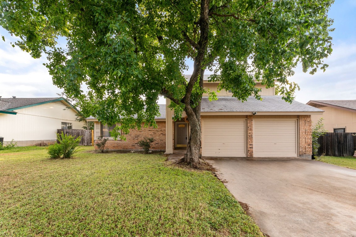 a view of a house with a yard and garage