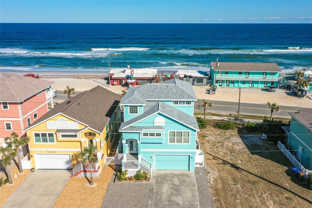 a view of residential houses with outdoor space and ocean view