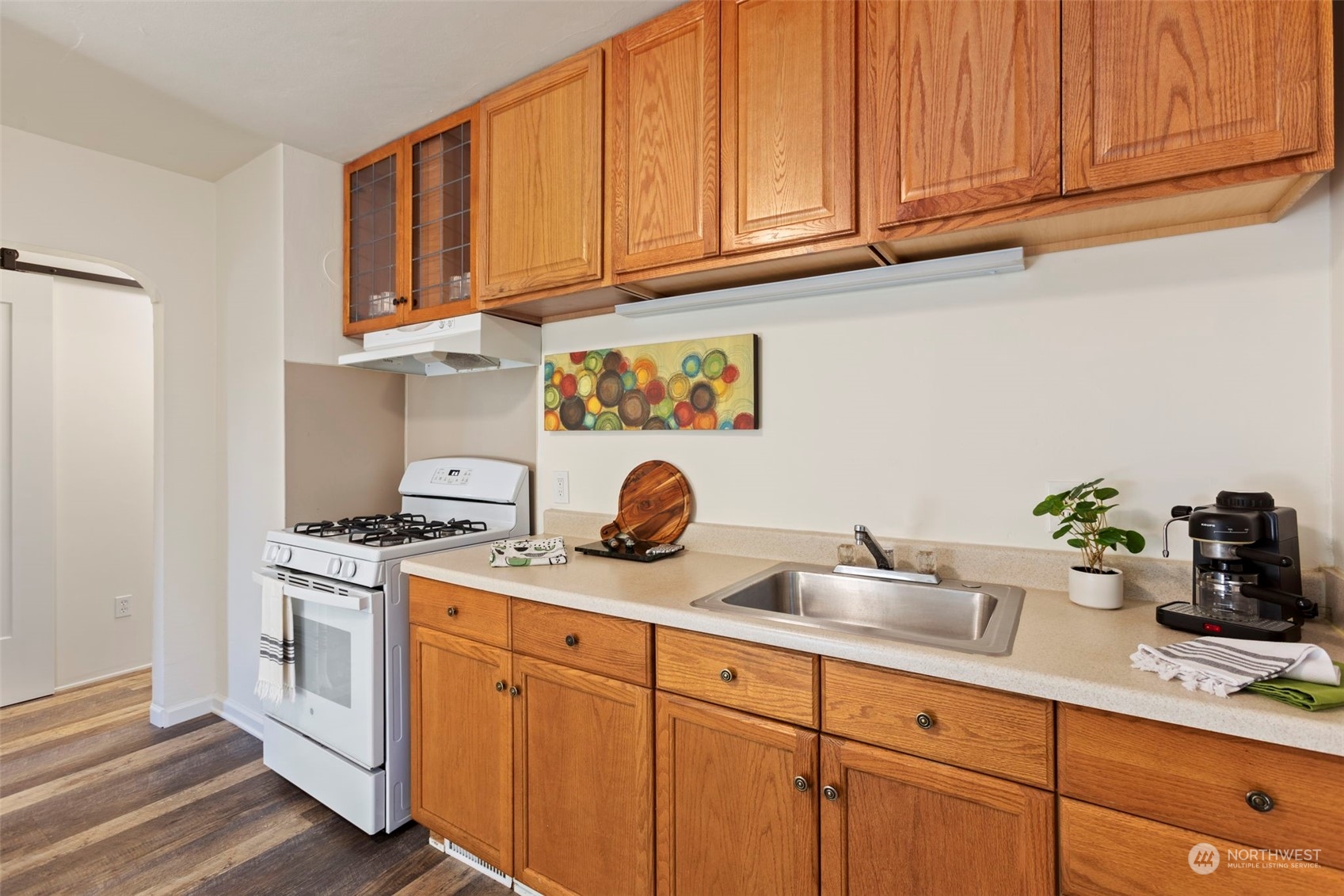 a kitchen with stainless steel appliances granite countertop a sink a stove and cabinets