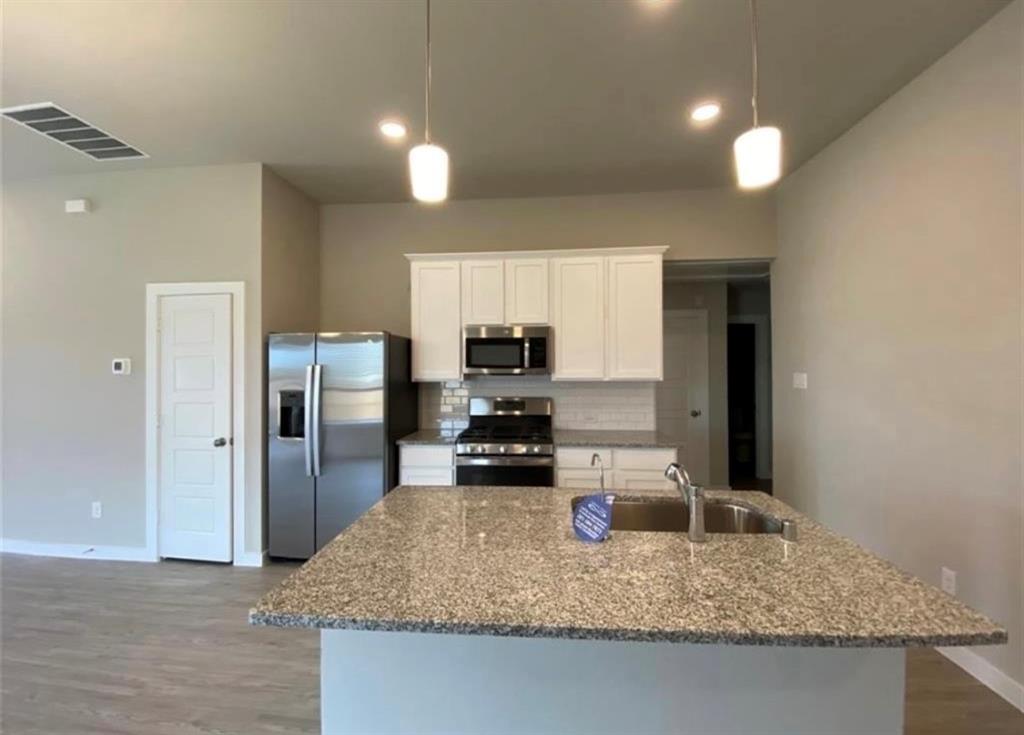 a kitchen with refrigerator and countertop