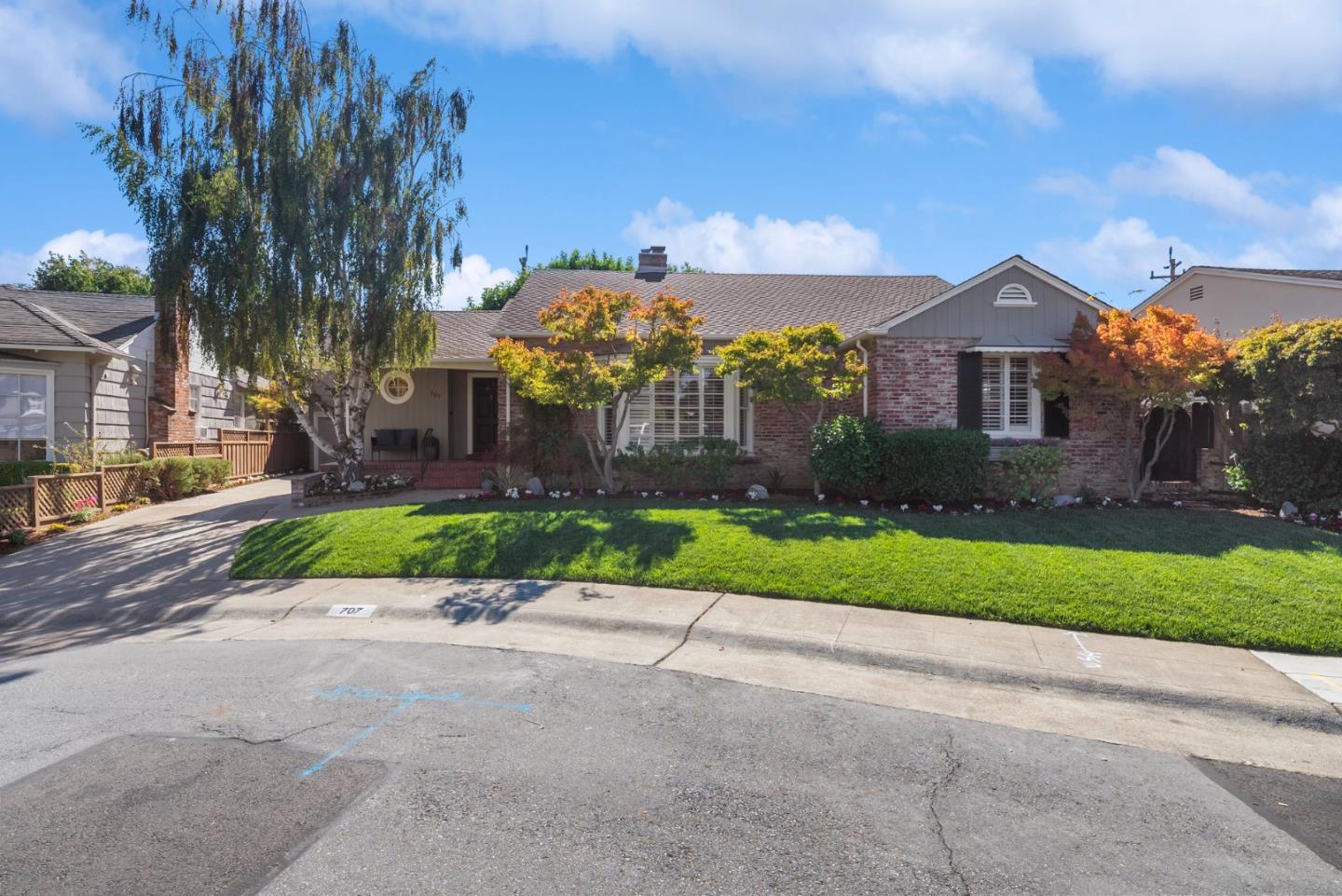 a front view of a house with a yard and a garage