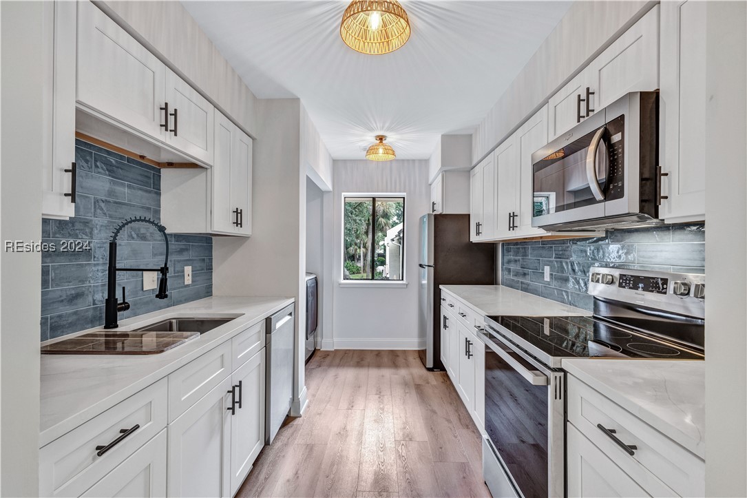 Kitchen with light hardwood / wood-style floors, s