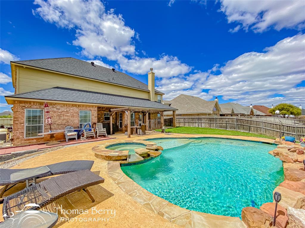 a view of a house with swimming pool and porch with furniture