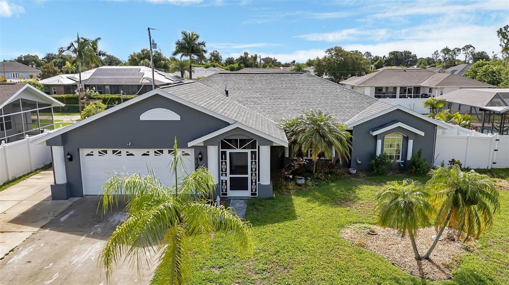 a aerial view of a house with a big yard and potted plants