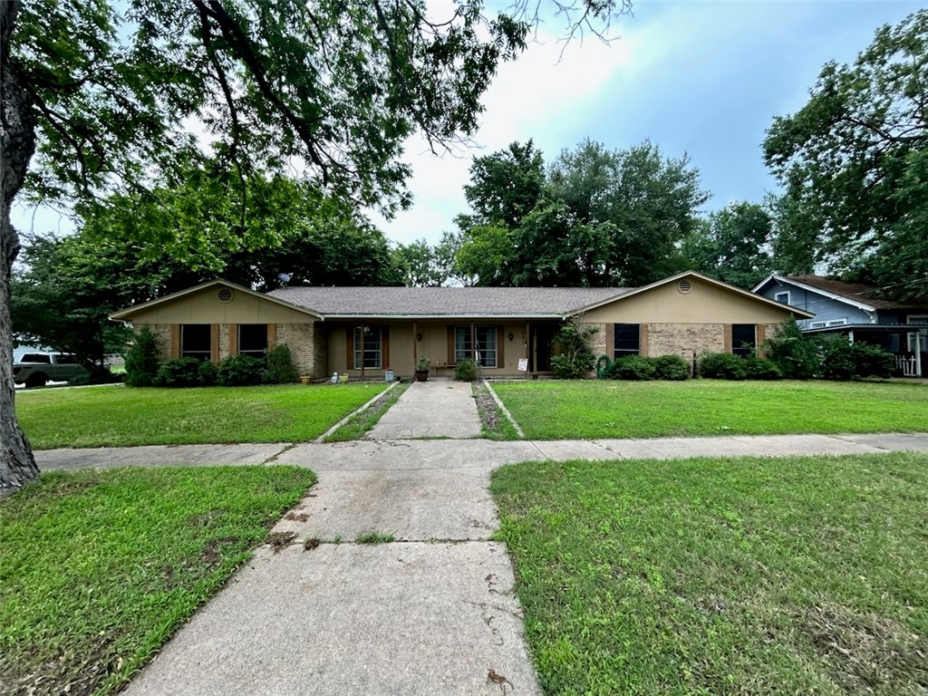 a front view of house with yard and green space