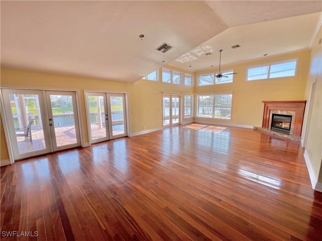 a view of an livingroom with wooden floor and a floor to ceiling window