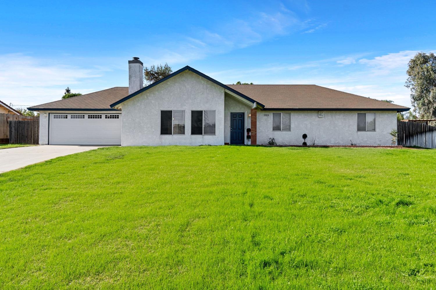 a view of a house with a yard and garage