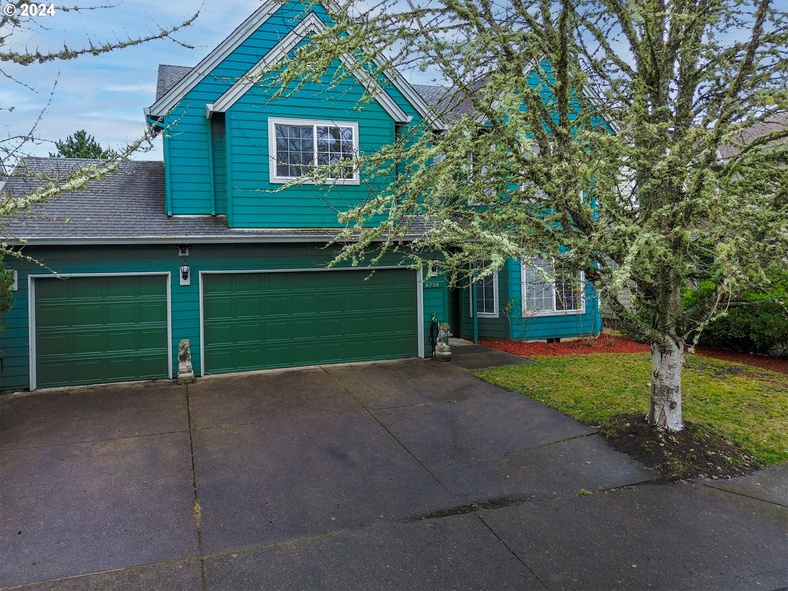 a view of a house with a yard and garage