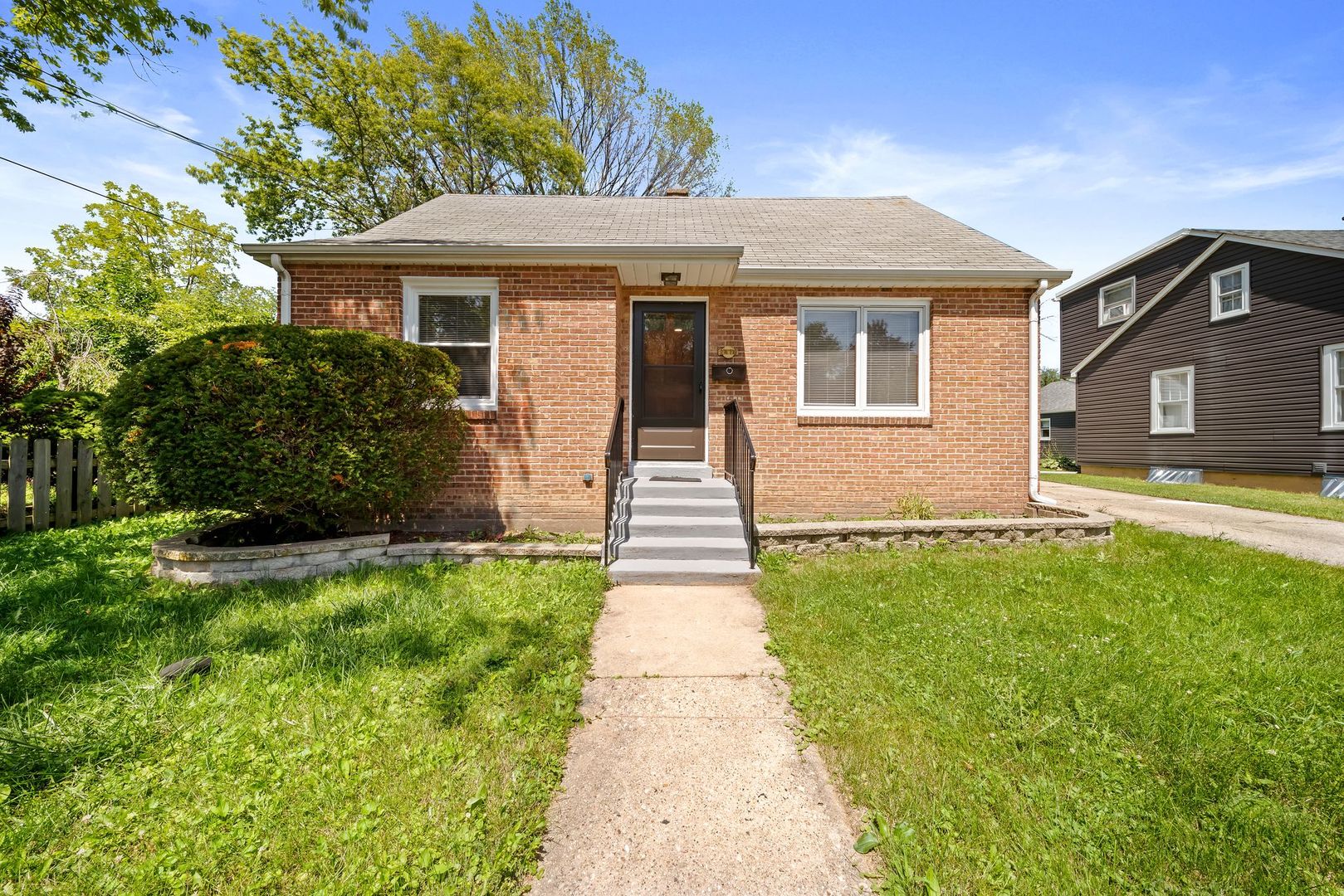 a front view of a house with a garden