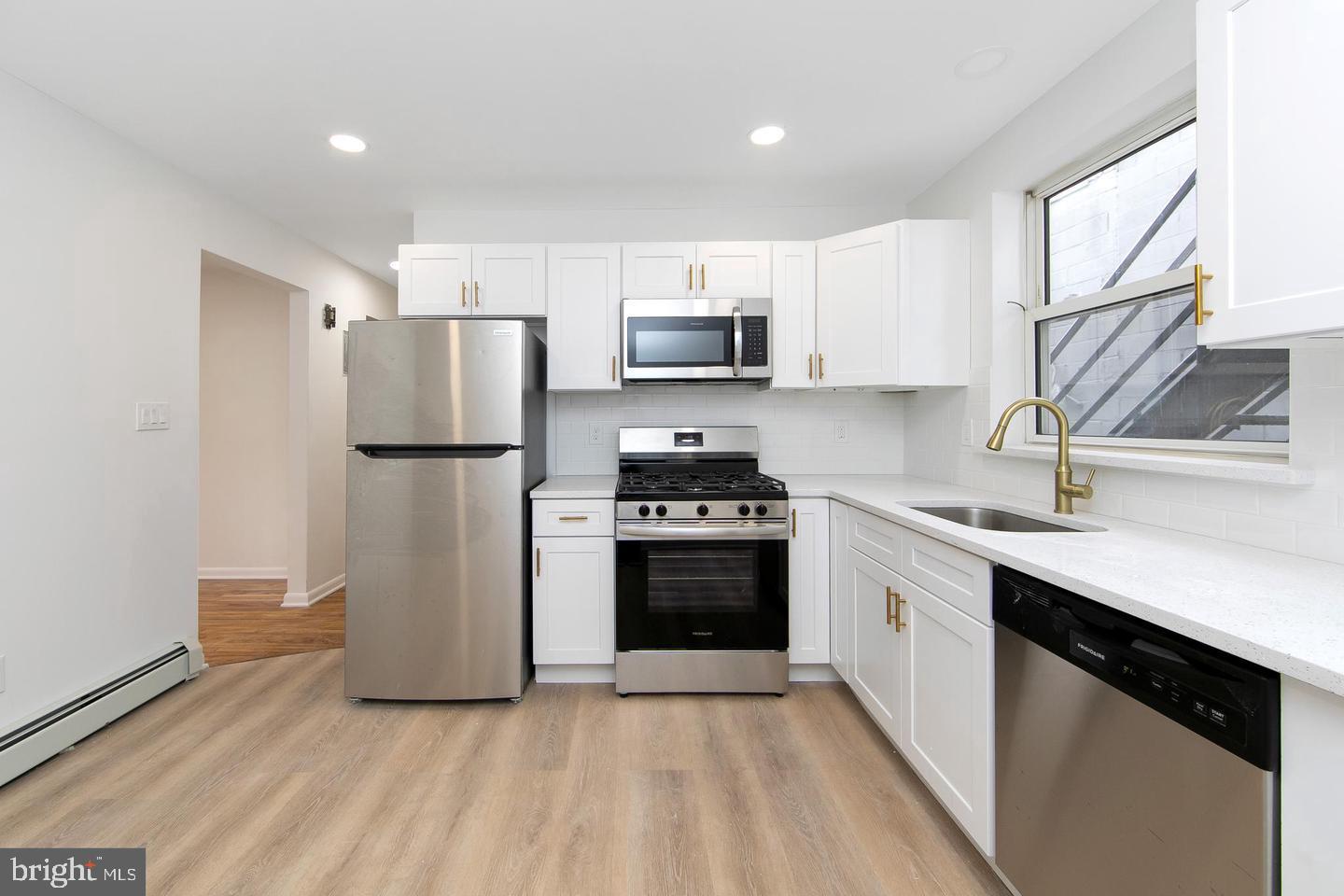 a kitchen with a refrigerator sink and microwave