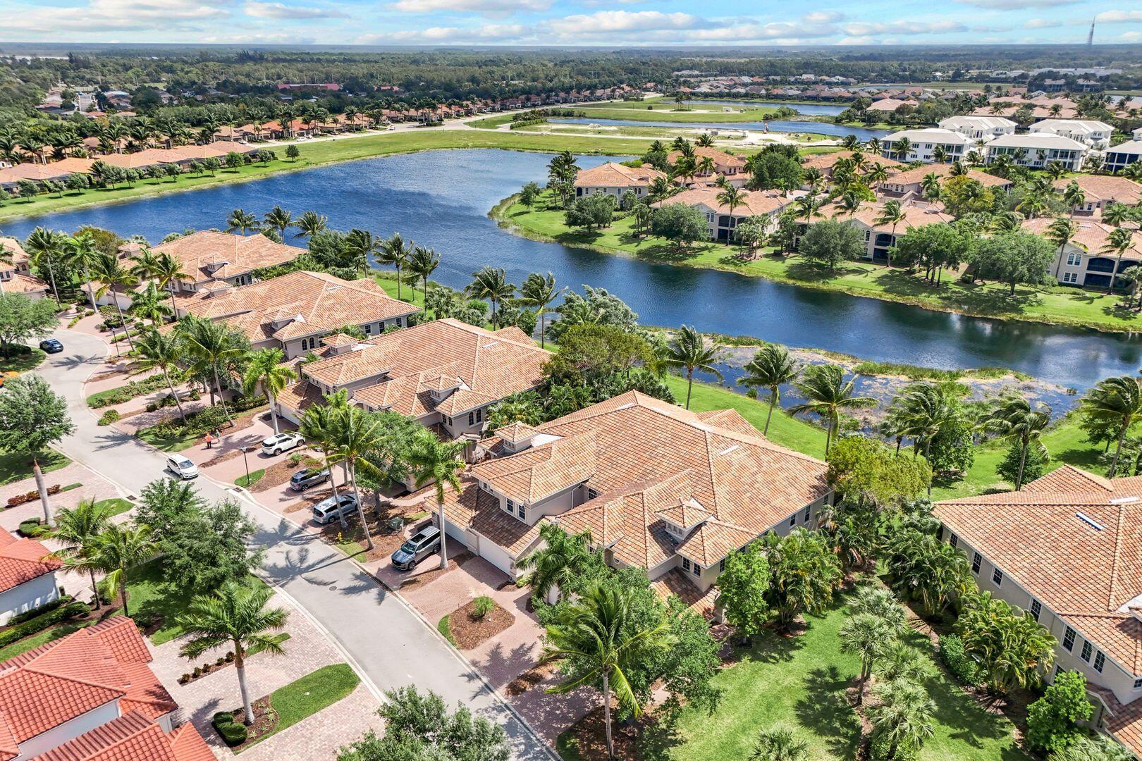 an aerial view of residential houses with outdoor space and river