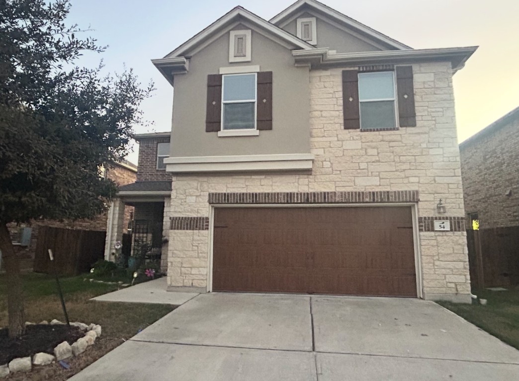 a front view of a house with garage