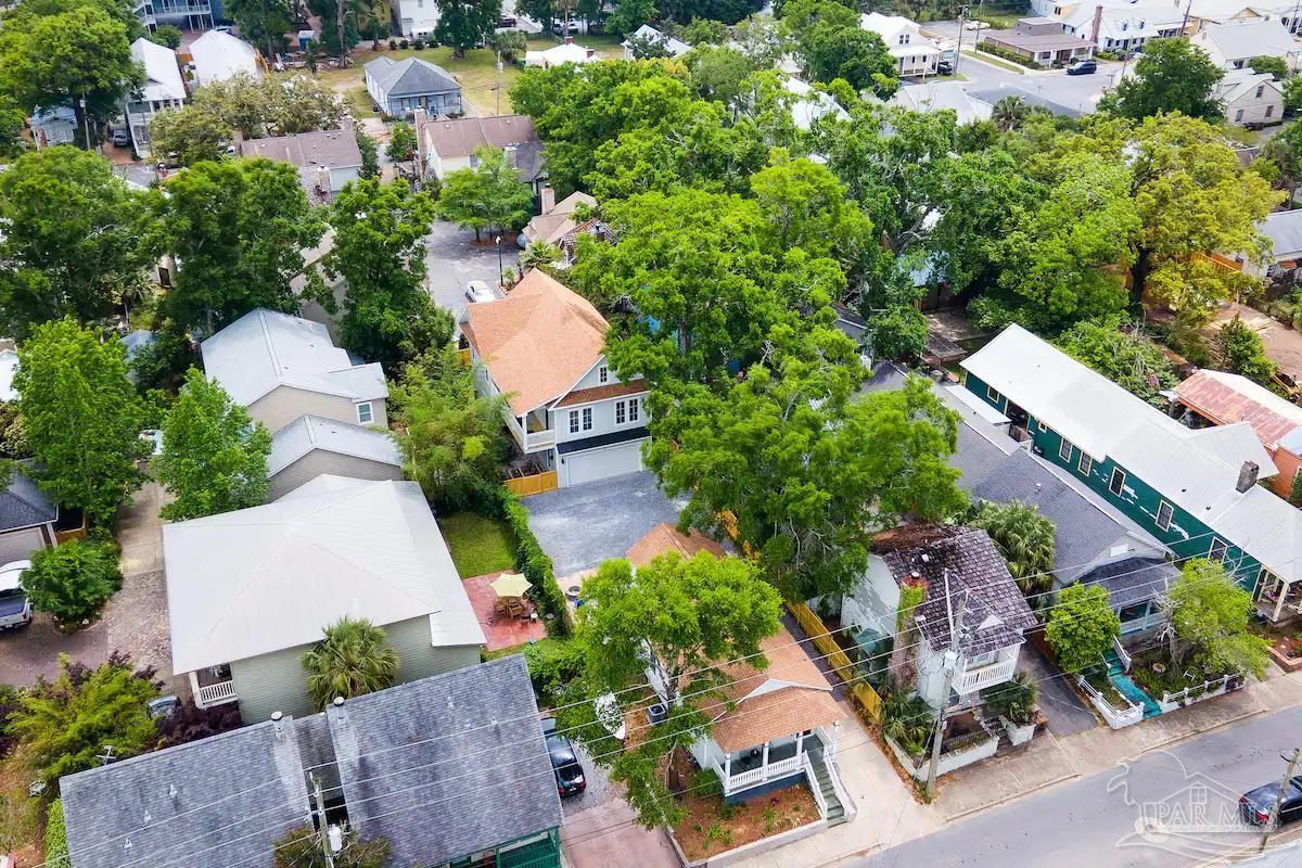 an aerial view of a house with garden space and street view