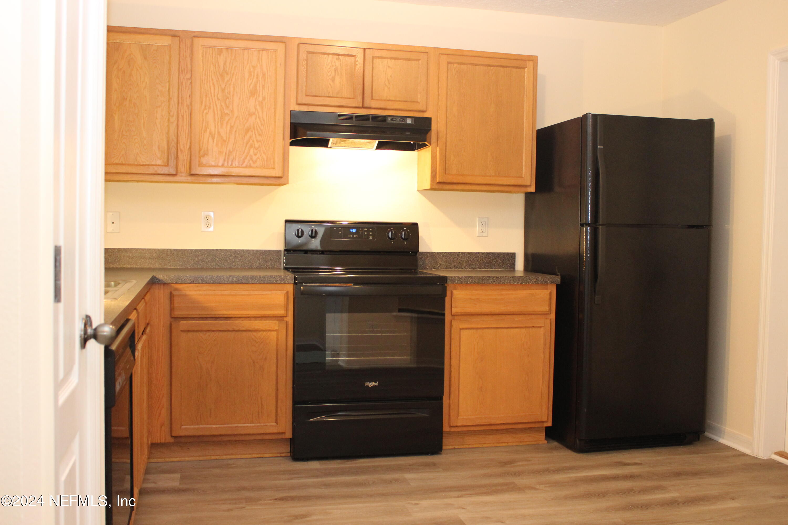 a kitchen with stainless steel appliances granite countertop a refrigerator and a stove