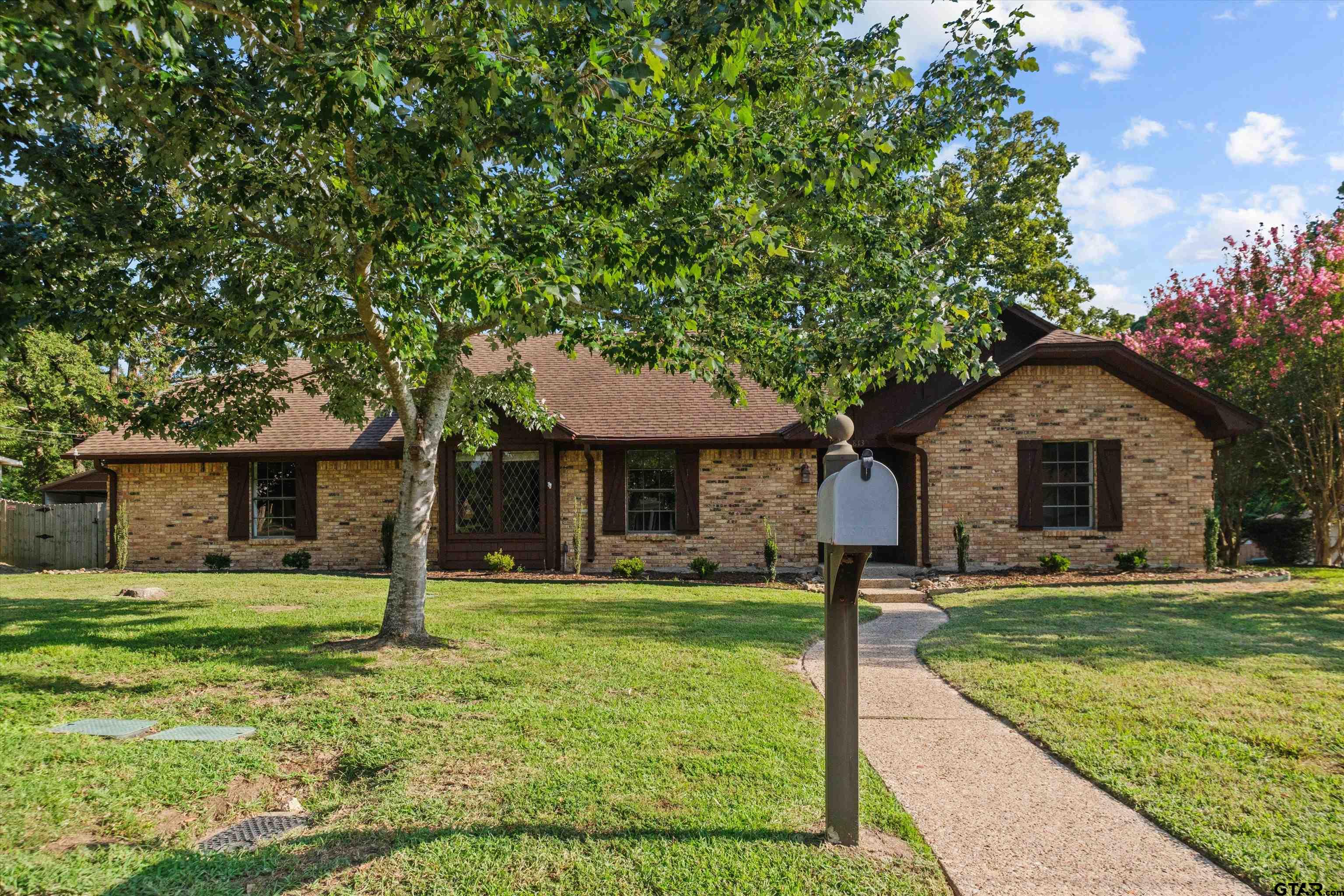 a front view of house with yard and green space