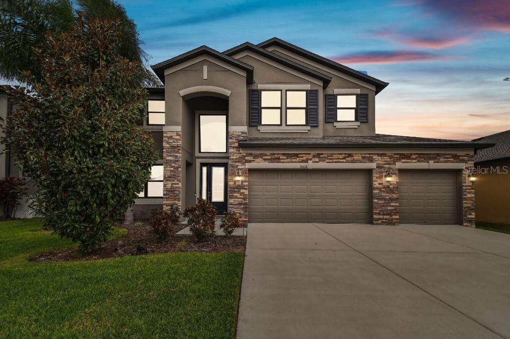 a front view of a house with garage