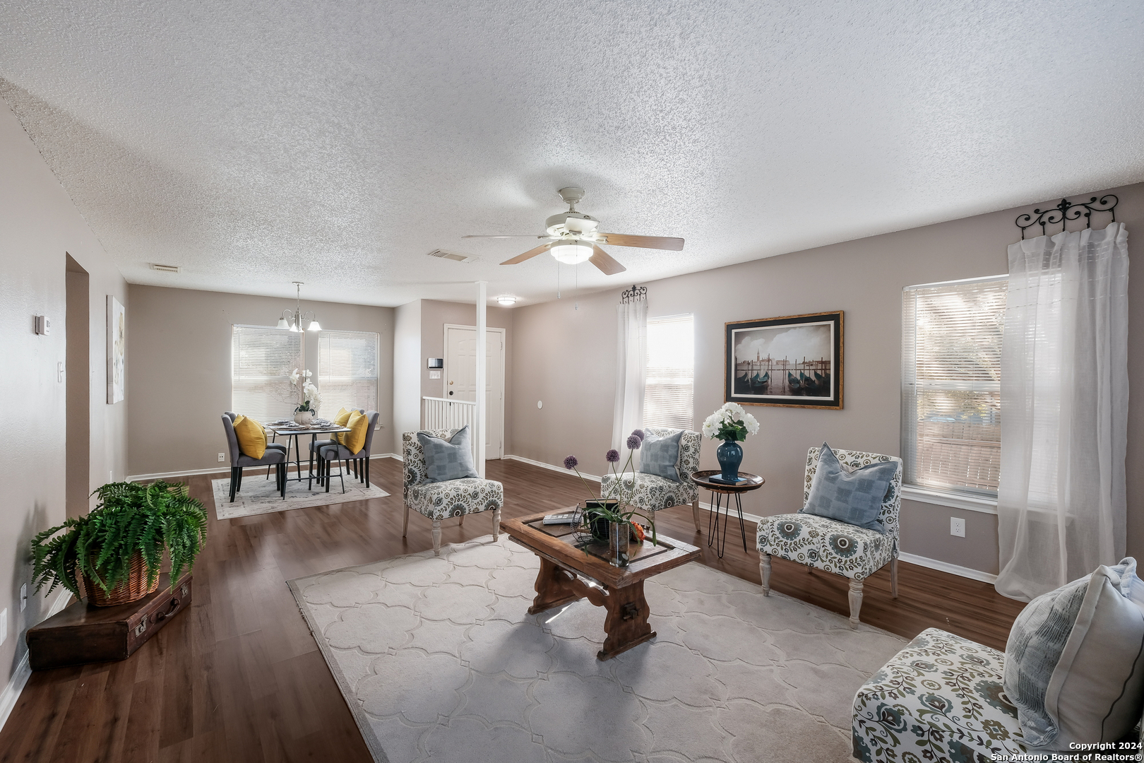 a living room with furniture and a wooden floor