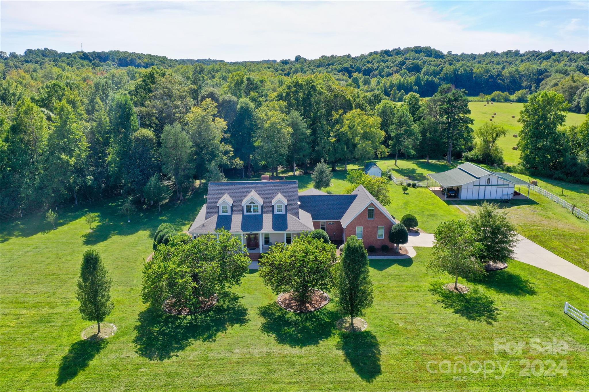 an aerial view of house with yard swimming pool and outdoor seating