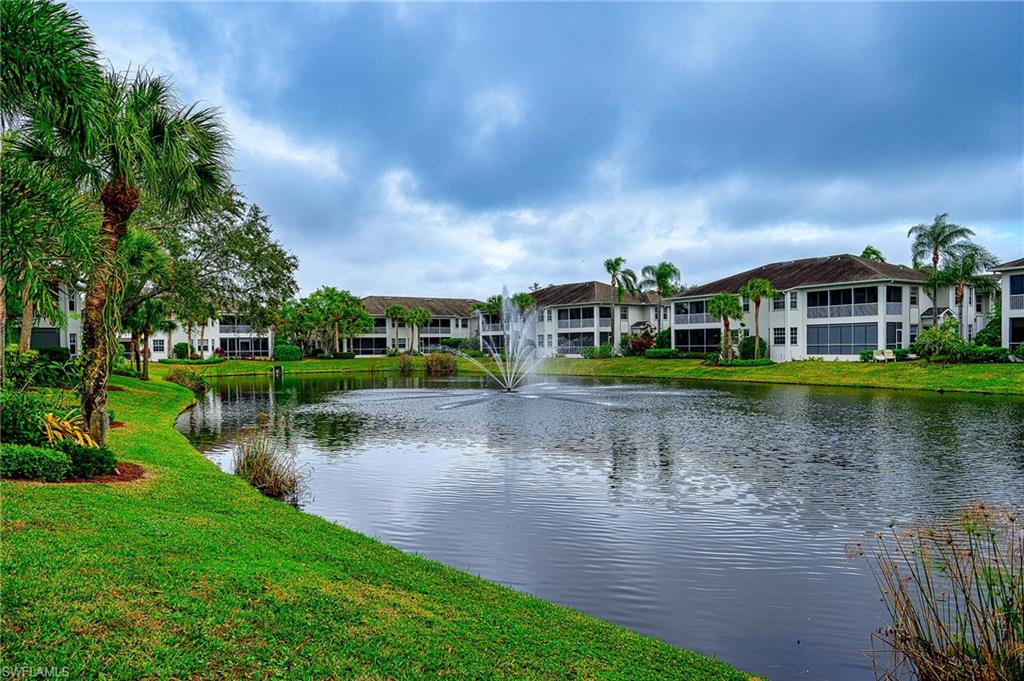 a view of a lake with houses in the back