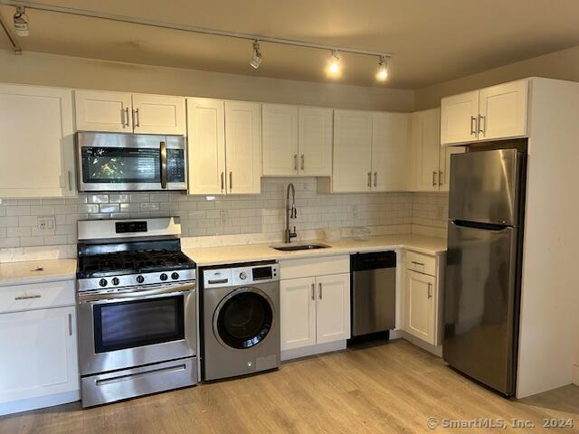 a kitchen with a stove microwave and refrigerator