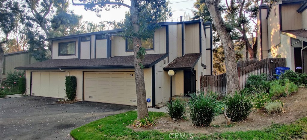 a house that has a tree in front of the house