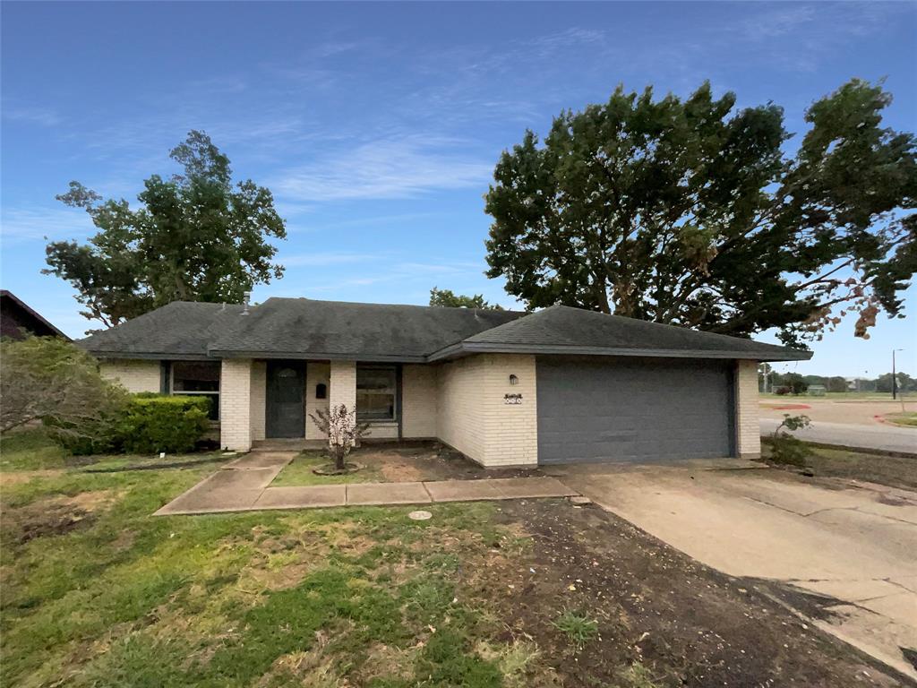 a front view of a house with a yard garage and outdoor seating