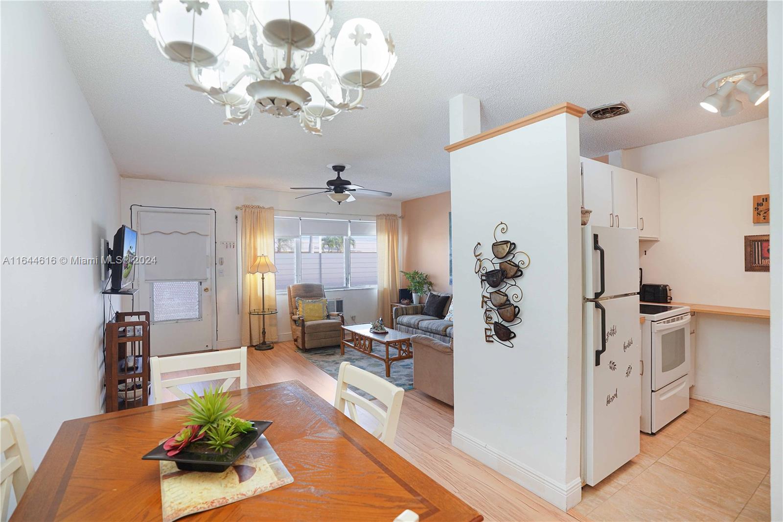 a living room with kitchen island furniture and a chandelier