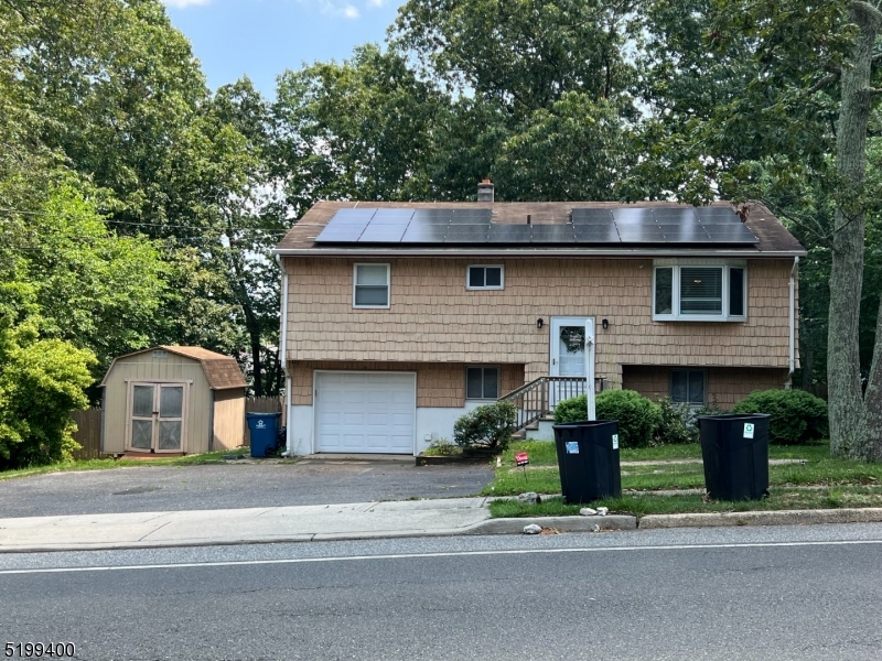 a front view of a house with a garden and plants