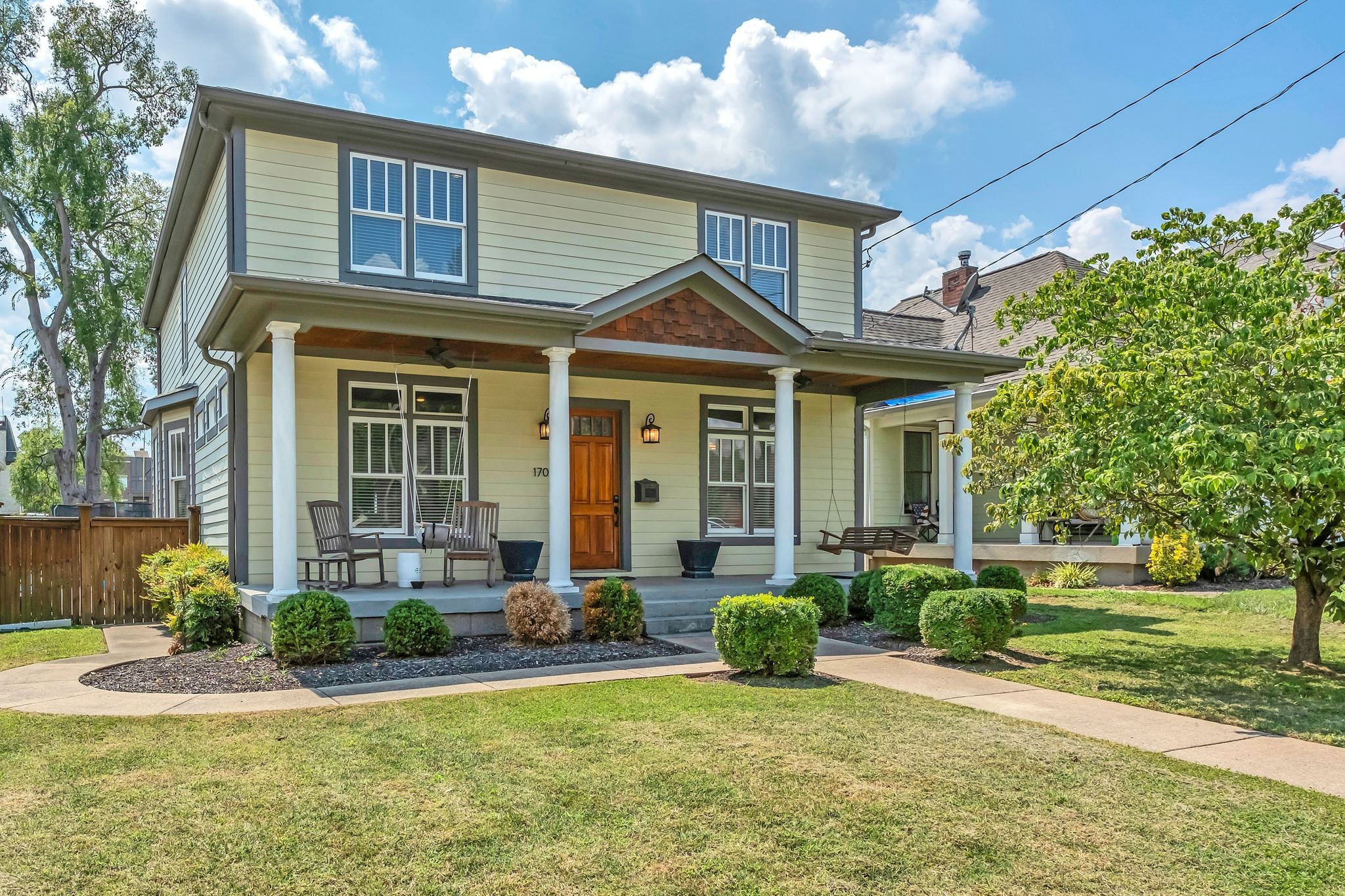 a front view of a house with a yard and porch