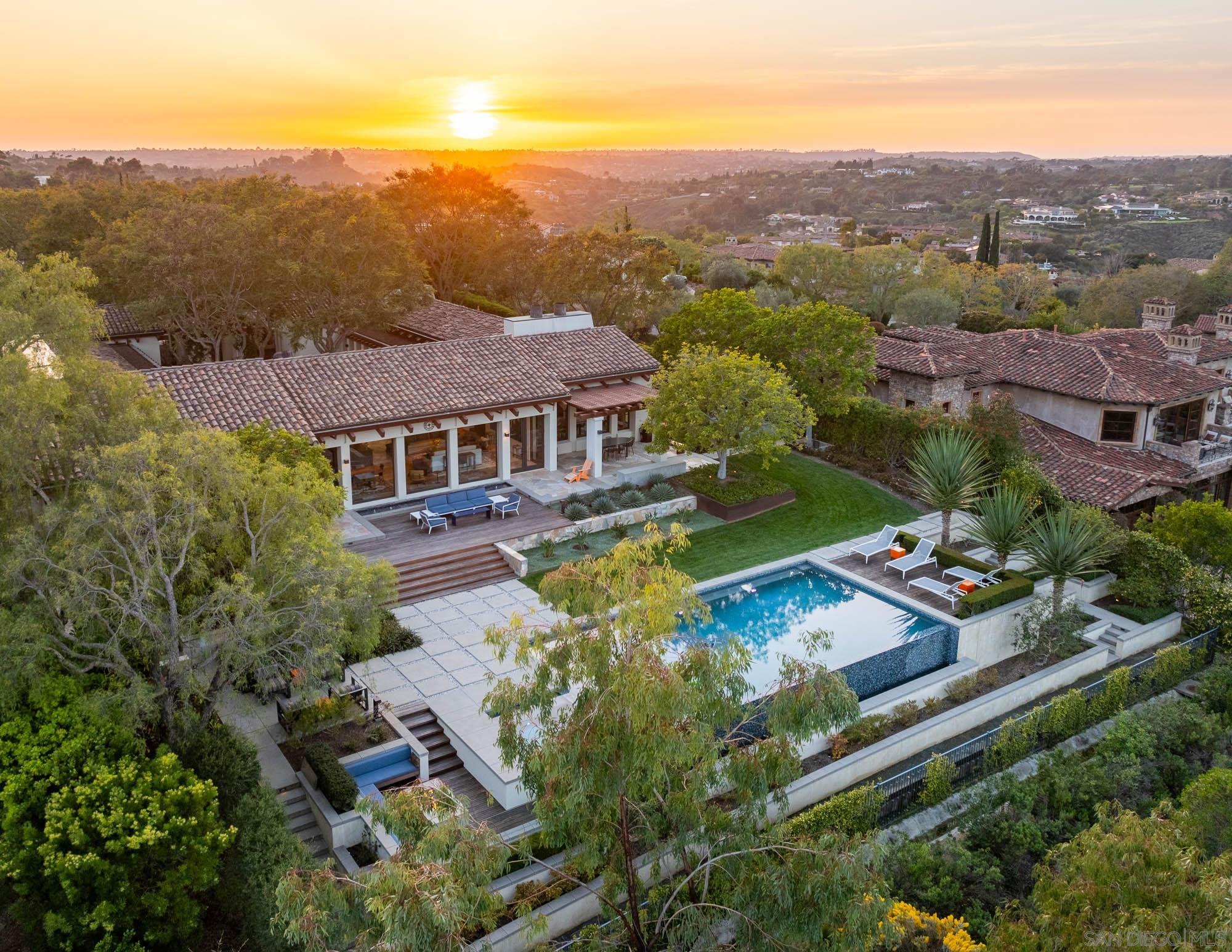 an aerial view of residential houses with outdoor space and swimming pool