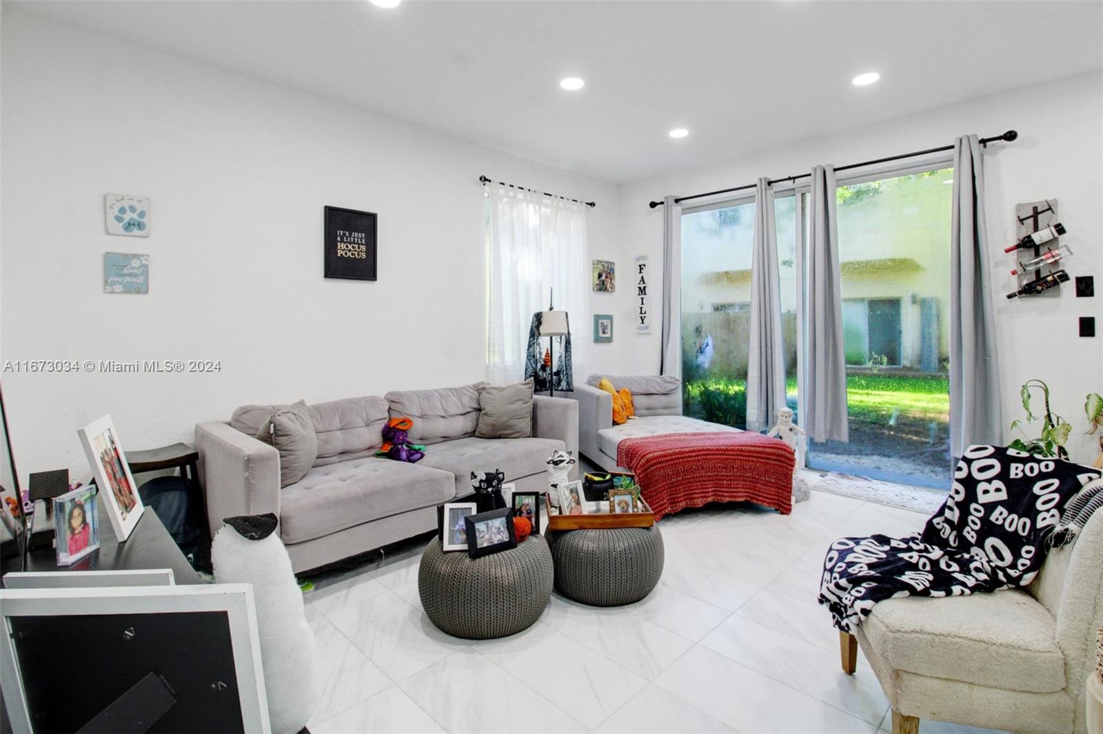 a living room with furniture ceiling fan and a rug