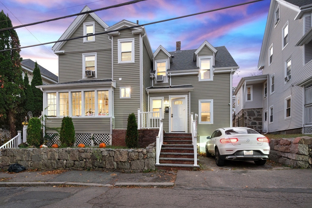 a couple of cars parked in front of a house