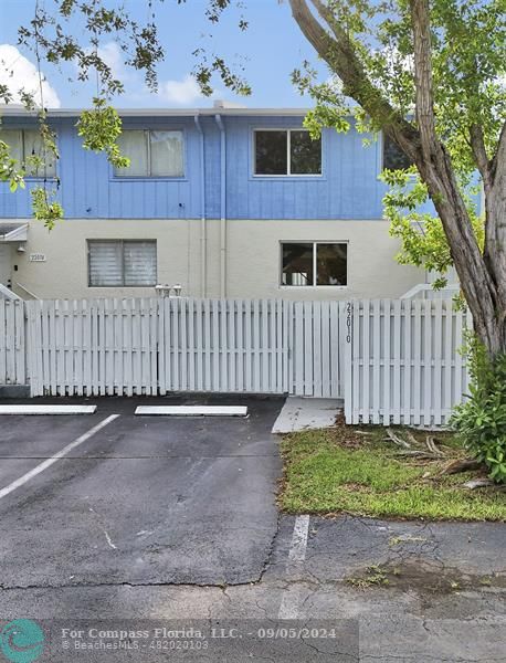 a front view of a house with a yard and a garage