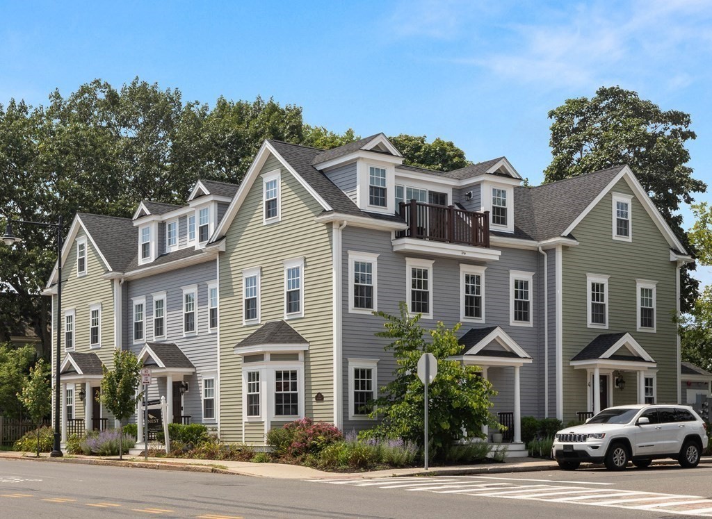 a front view of a residential apartment building with a yard