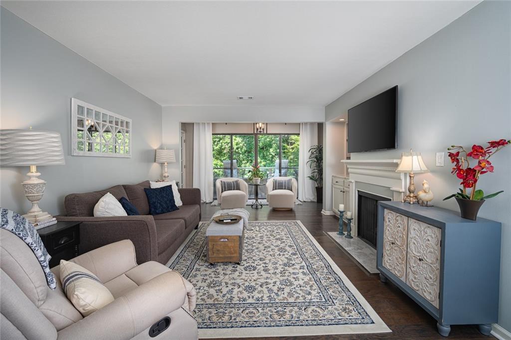 a living room with furniture fireplace and flat screen tv