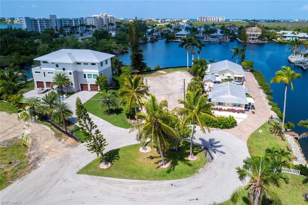 an aerial view of a house with a garden and lake view