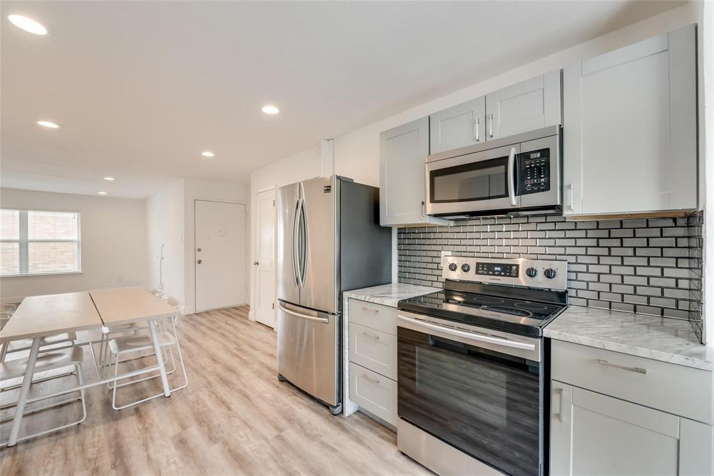 a kitchen with wooden cabinets and stainless steel appliances