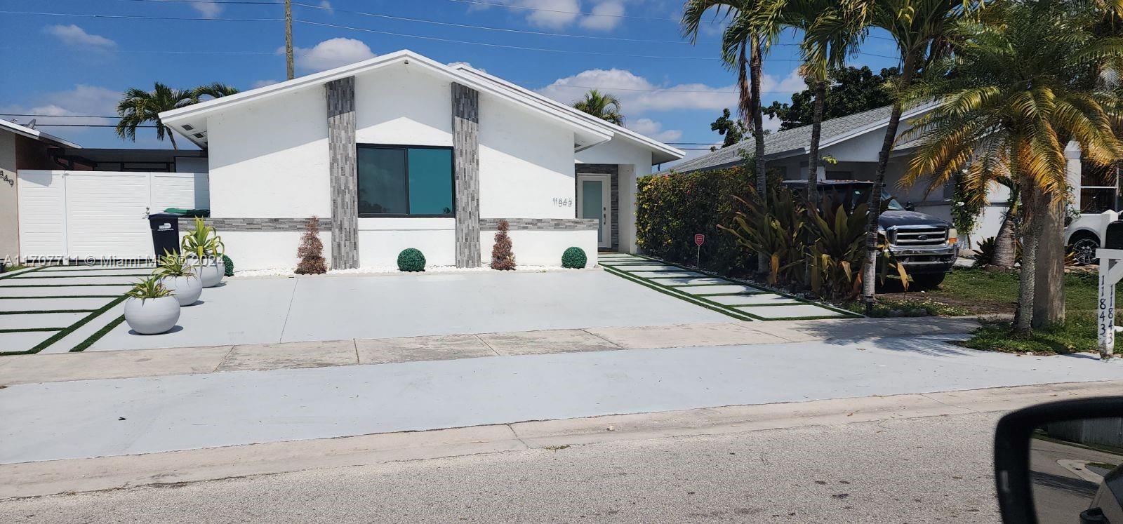 a view of house with outdoor space and parking