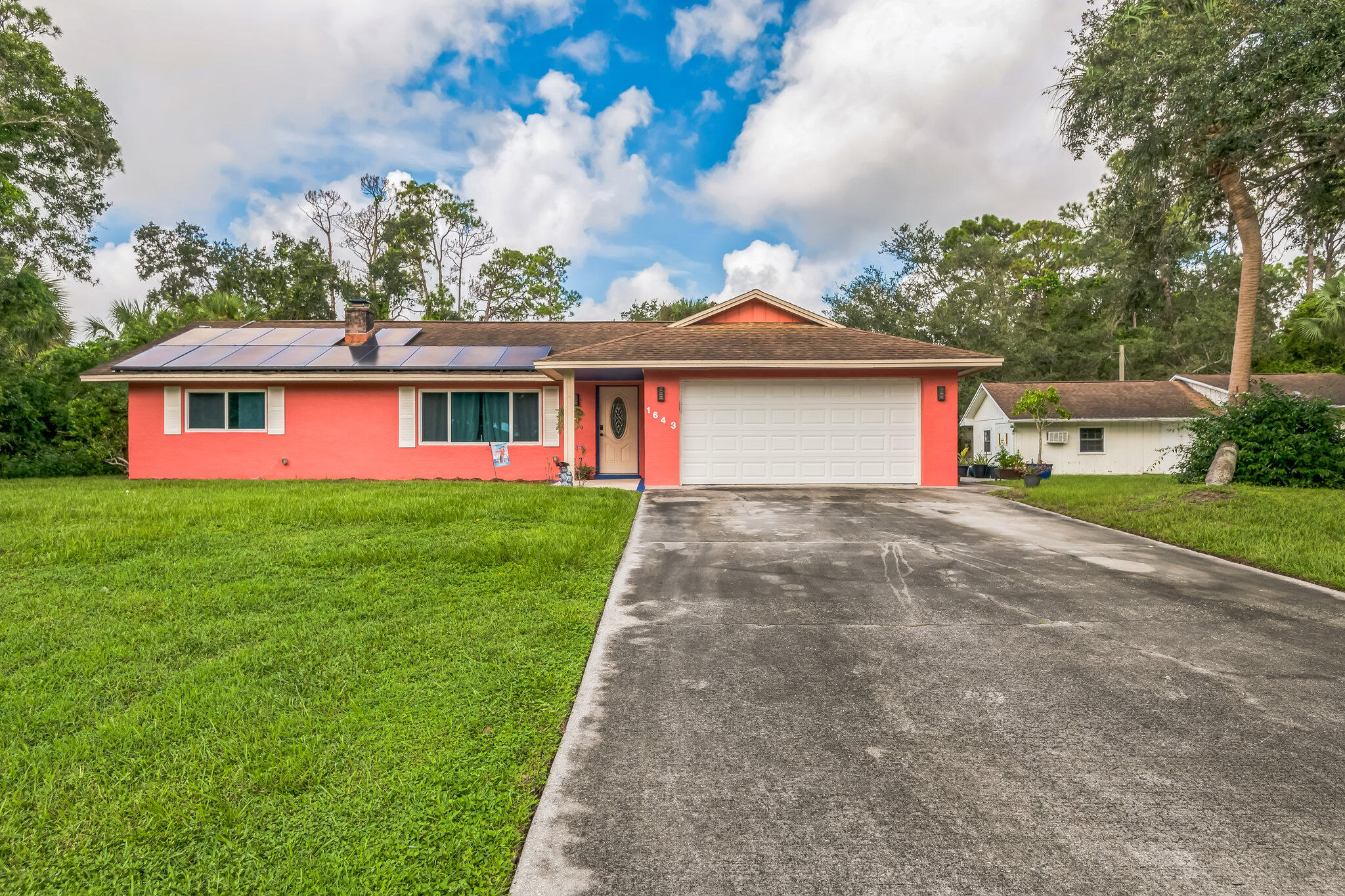 a front view of house with yard and green space