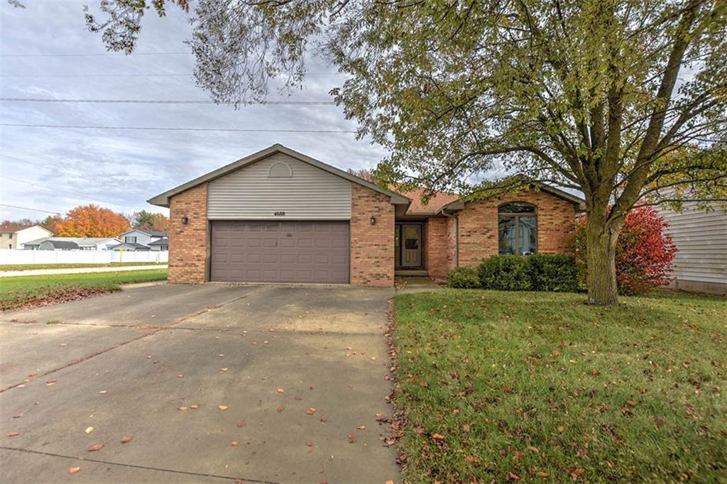 a brick house with trees in front of it