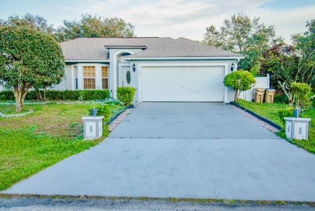 a front view of house with yard and green space